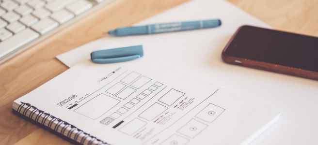 blue pen beside black smartphone on white paper